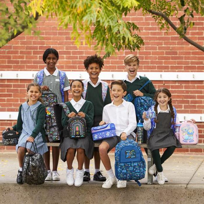 Smiling children wearing back to school items from Smiggle